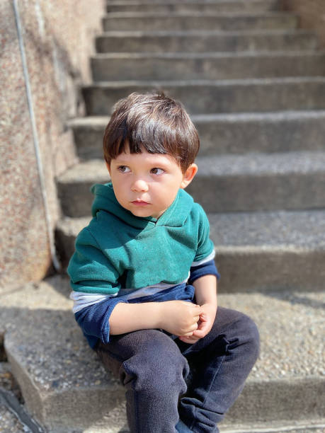 istock Toddler sitting at stairs 1473604846