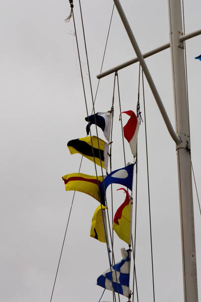 istock Nautical Signal Flags Flying From Flag Pole 1473605735