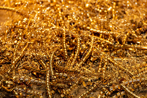 Close-up scene of  brass materials scrap from turning process. The pile of lathe chips.