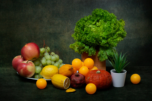 Still life with fruits and vegetables, plants and balls