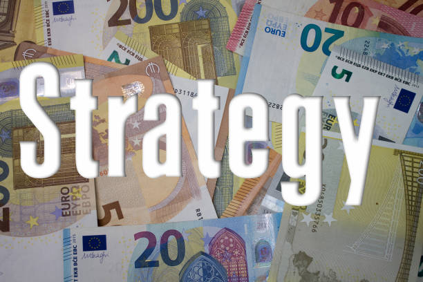istock Strategy word with money. Paper currency background with different banknotes. 1473615888