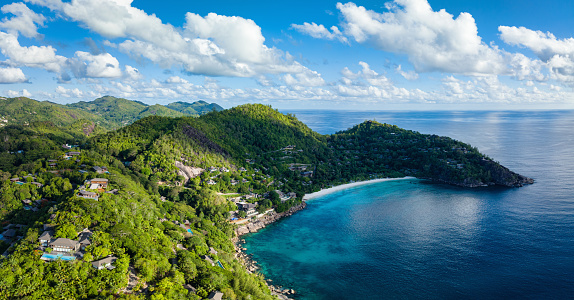 Seychelles Petite Anse Beach at the Anse La Liberte Coast XXL Stitched Panorama on Mahe Island. Drone view overlooking the beautiful small Petite Anse Beach. Anse la Liberte Indian Ocean Coastline and tropical Hill Range. South-West Coast on Mahé Island. Petite Anse, Mahe Island, Seychelles Islands, East Africa