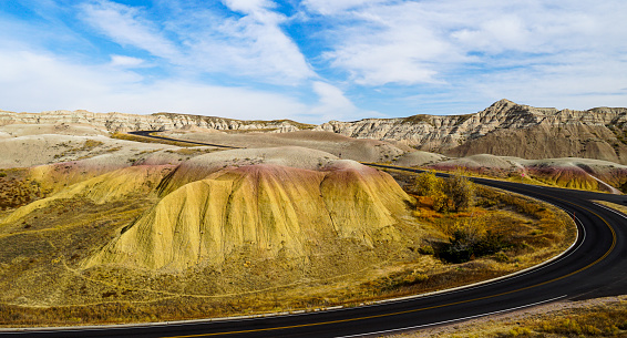 Landscape of Badlands National Park yellow mounds with road