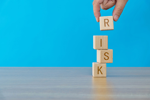 Wooden cubes with word risk.