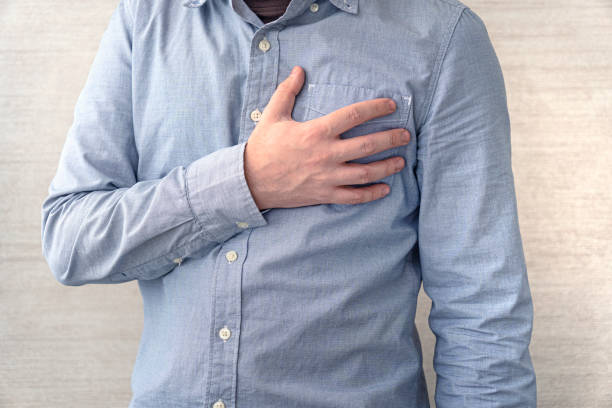 istock heart problems. Cardiac diseases. People, healthcare and problem concept. man suffering from heartache over white background. heart problems. 1473623471