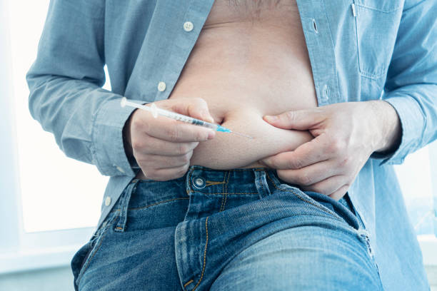 injecting insulin at home. young man hand using insulin syringe close up . self-medication young man hand using insulin syringe close up . injecting insulin at home. self-medication patient blood management stock pictures, royalty-free photos & images