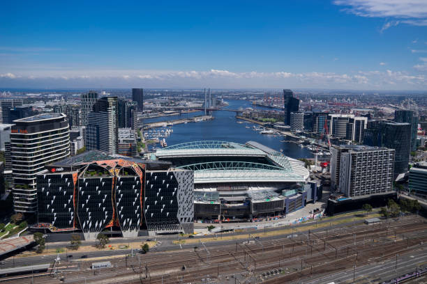 Melbourne, Australia - March 11, 2023: Office buildings, the Marvel Stadium, Bolte bridge and apartments around Victoria Harbour in the Docklands precinct at dusk.