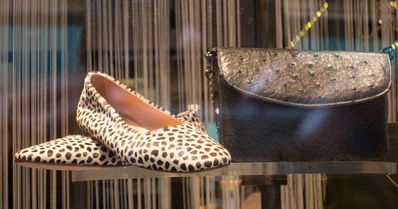 Woman Flat Shoes with Purse in Fashion Store Display Window in Venice