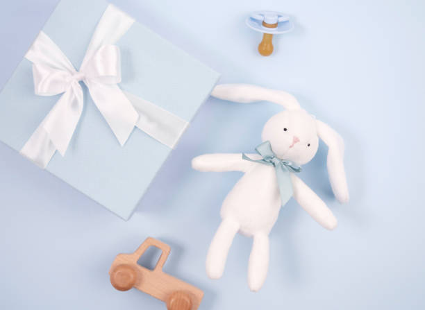 istock A box with a toy bow and other accessories on a blue background. 1473633070