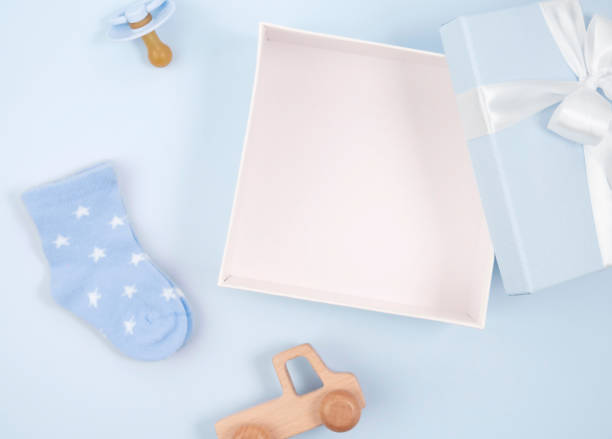 istock A box with a toy bow and other accessories on a blue background. 1473633084