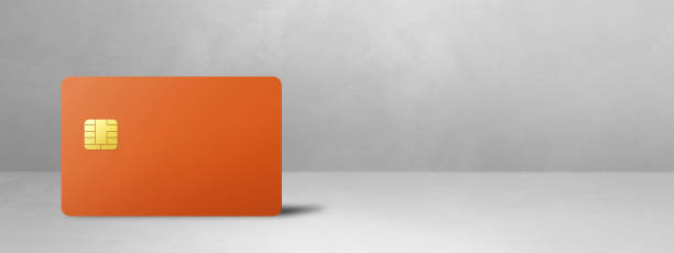 istock Orange credit card on a white concrete background 1473633851