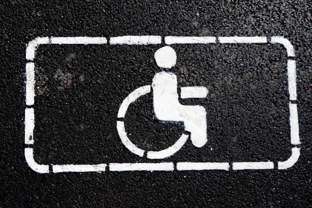 Handicap symbol on road. Road marking on the asphalt with parking spaces for the disabled. Handicap symbol on road. Road marking on the asphalt with parking spaces for the disabled. wheelchair symbol of disabled parking lot for handicapped person on concrete road pavement ends sign stock pictures, royalty-free photos & images