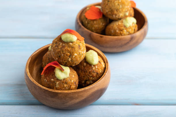 istock Falafel with guacamole on blue wooden. Side view. 1473633887