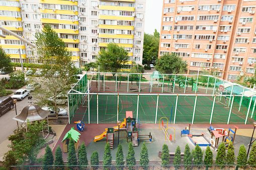 view from above from the window. sports and children's playground in the courtyard of a multi-storey building.