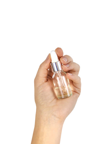 istock Oil in spa bottle in woman hands isolate. Selective focus. 1473634916