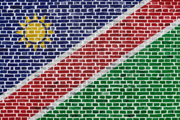 Close-up on a brick wall with the flag of Namibia painted on it.