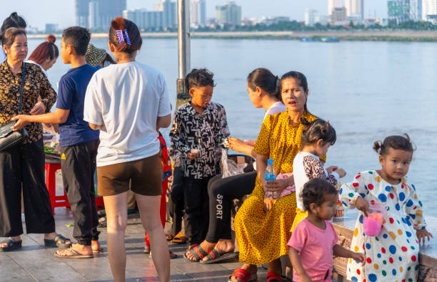 Phnom Penh,Cambodia-December 23 2023: The Riverside Promenade,is a nce place for Khmer families to to come to eat,pray and socialize,next to the Tonle Sap,in the relative cool of a late afternoon.