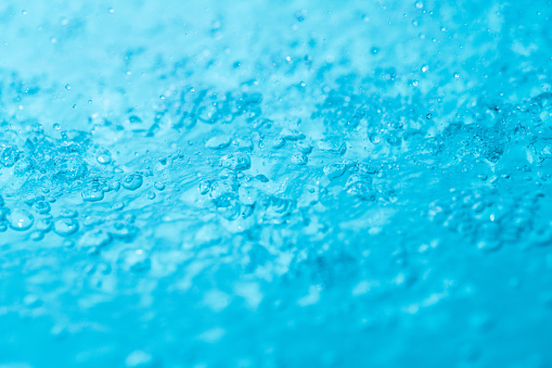 Bubble soda and blue oxygen air, in underwater clear liquid with bubbles flowing up on the water surface, isolated on a white background