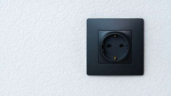 An electrical outlet on white wall