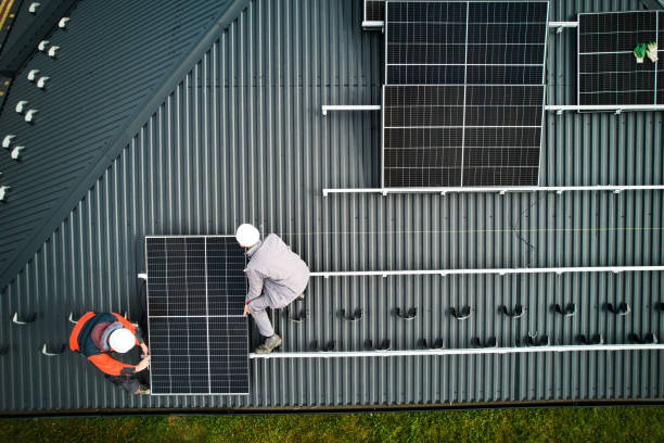 istock Men workers installing solar panels on roof of house. 1473638767