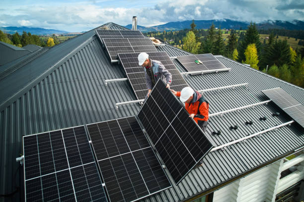istock Men workers installing solar panels on roof of house. 1473638792