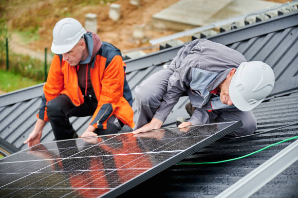 istock Men workers installing solar panels on roof of house. 1473638892