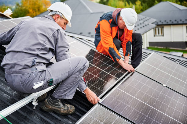 istock Men workers installing solar panels on roof of house. 1473638904