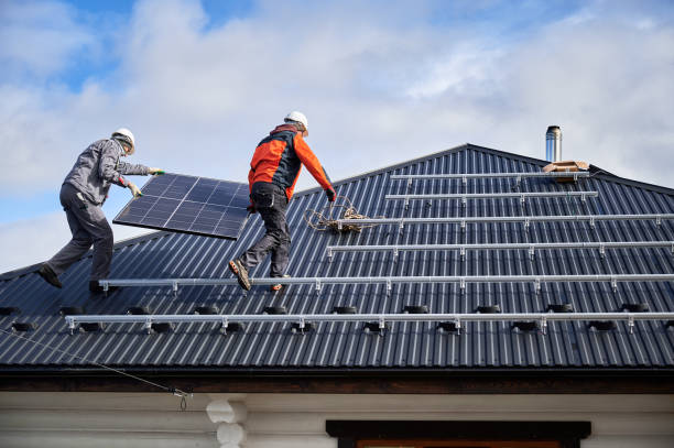 istock Workers carrying solar panel on a roof of house 1473638926