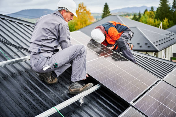istock Men workers installing solar panels on roof of house. 1473638932