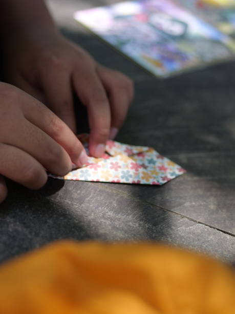 istock Selective focus Learn to fold paper. Child making origami at table. Selective focus. 1473638961