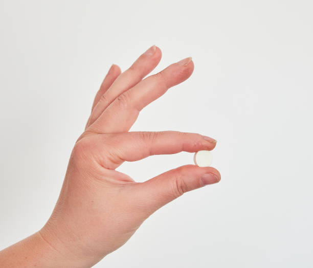 istock Close-up shot of pill in nurse's hand. 1473639186