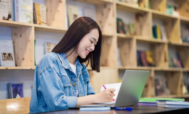 istock Young Asian girl studying at library 1473639530