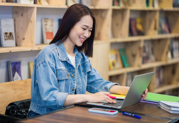 istock Young Asian girl studying at library 1473639533