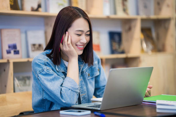 istock Young Asian girl studying at library 1473639540