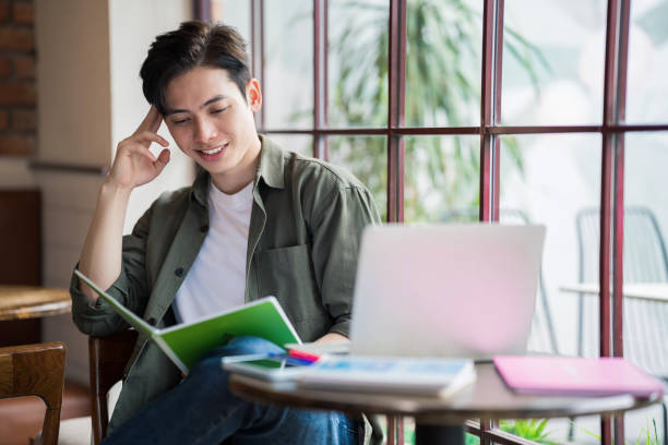 istock Young Asian businessman working at coffee shop 1473639559