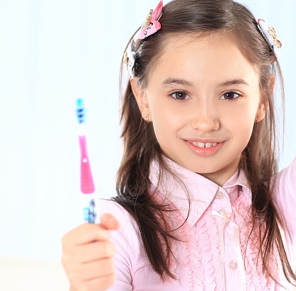 little girl with toothbrush.photo with copy space.