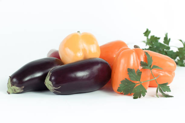 bell pepper,eggplants and sprigs of parsley on a white background.photo with copy space