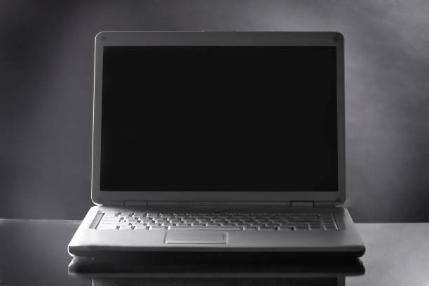 istock close up. opened laptop on dark background 1473640745