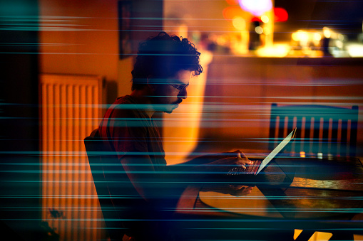 Young Computer Programmer Working On His Computer At Night With ...