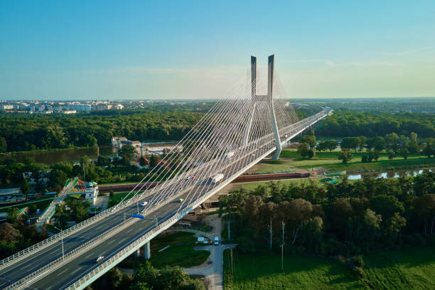 istock Large cable stayed bridge over river with car traffic, aerial view 1473641882