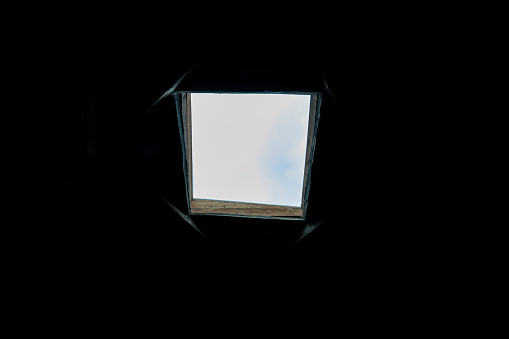 The sunroof is the source of the light in the image with the emphasis on the sunroof's light. Photograph gives the concept of hope in the darkness. Photograph provides a big copy space.