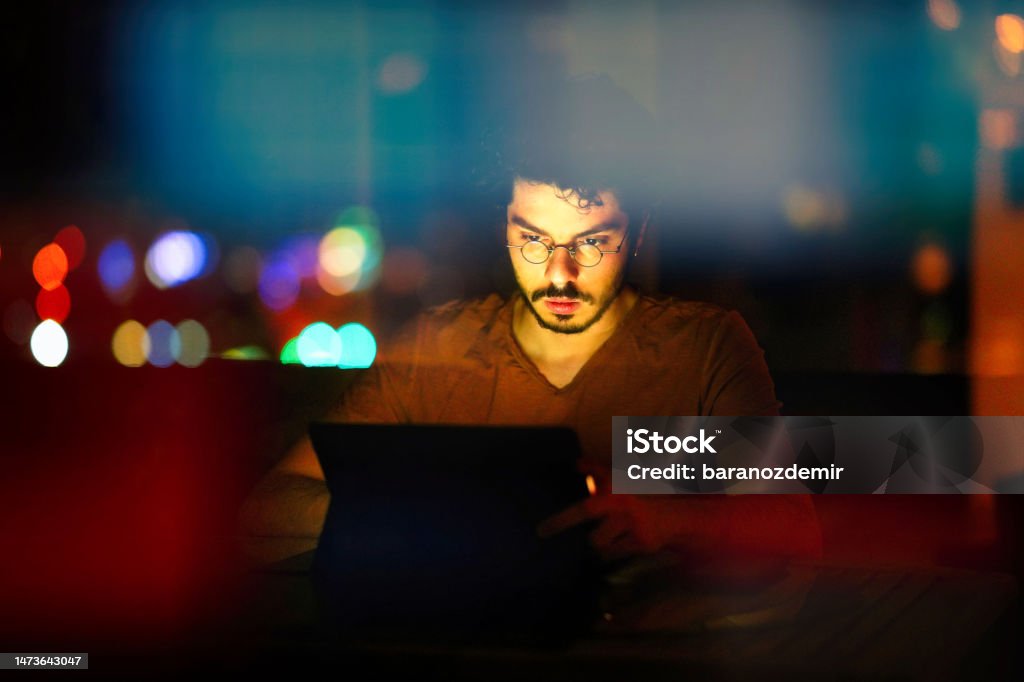 Young Computer Programmer Working On His Computer At Night With ...