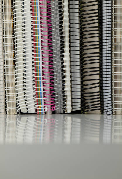 istock Still life of spiral notebooks on white table with reflection 1473643325