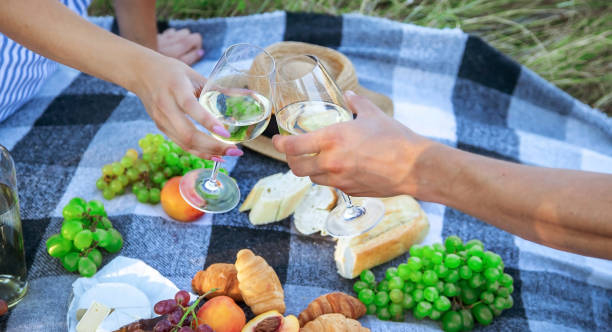 istock couple in love drinking white wine on a picnic. Selective focus. 1473643544