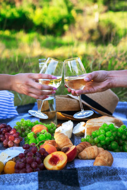 istock couple in love drinking white wine on a picnic. Selective focus. 1473643548