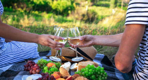 istock couple in love drinking white wine on a picnic. Selective focus. 1473643549