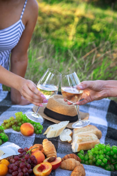 istock couple in love drinking white wine on a picnic. Selective focus. 1473643553