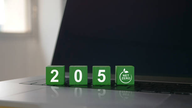 istock Net zero by 2050 on green wooden block placed on computer keyboard. It is a concept for natural environment neutral carbon A climate-neutral long-term strategy greenhouse gas emissions targets. 1473643966