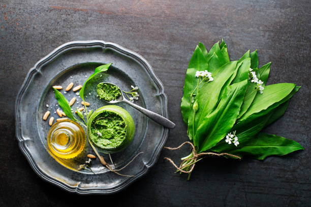 Ramson or wild garlic pesto with fresh leaves stock photo