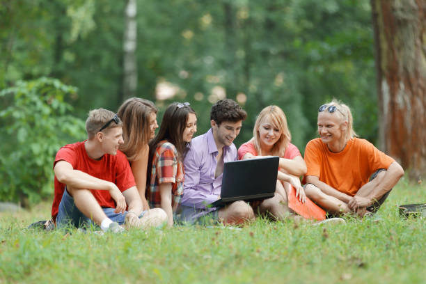 istock Group of college students studying together on campus ground 1473645345